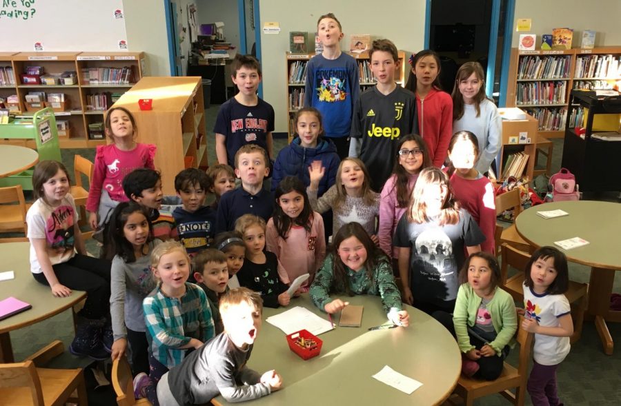 Reporters for the new Husky Howl newspaper pose in the newsroom at Hosmer Elementary School in Watertown, Mass., on Jan. 22, 2019.